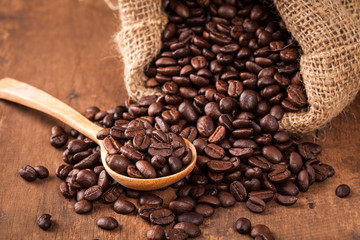 coffee bean on the wood table with spoon and sack
