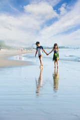 Fototapeta premium Brother sister holding hand walk on the beach