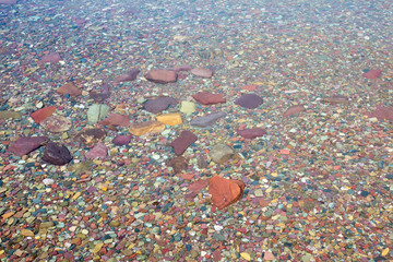 Colorful stones under the clear water of Lake McDonald. Glacier