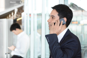 Asian businessman using cell phone