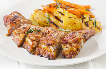 Grilled Pork Ribs and Vegetables on a White Plate.