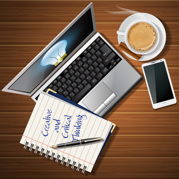 booklet and laptop with mobile phone and coffee cup