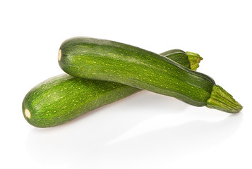 Two green zucchini isolated on white background