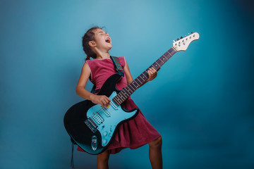 Teenage girl playing electric guitar studio background photo sta