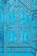 Close up of blue painted richly decorated baroque steel door