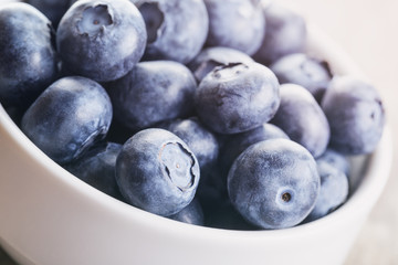 fresh blueberries in bowl on wood table