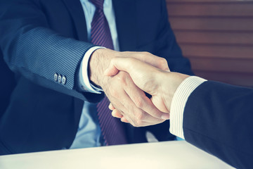 Handshake of businessmen in vintage tone