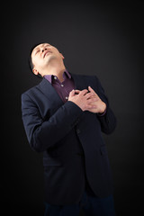 handsome man doing different expressions in different sets of clothes: heart attack