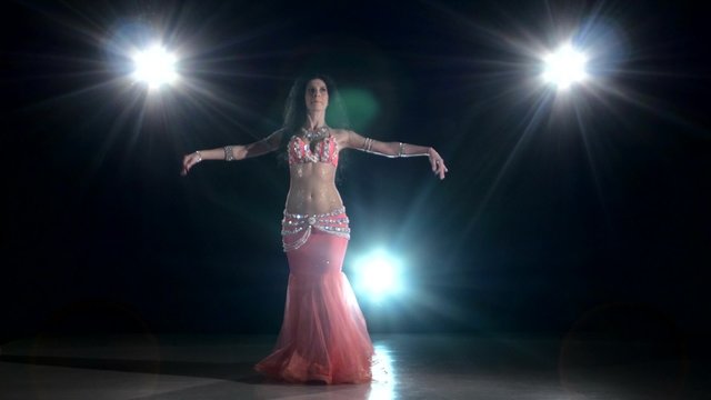 Exotic long-haired belly dancer girl starting dancing exotic