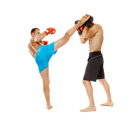 Kickboxers sparring on white