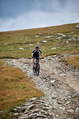 Obraz premium Mountain biker on trails