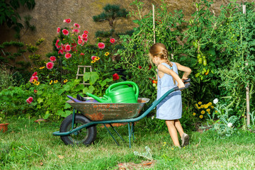 Cute little girl gardening in the backyard