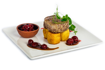 Steak meat served with potato and cherry jam on the plate at restaurant