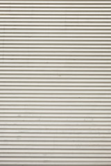 Fototapeta premium Steel shiny rolling shutter door texture with horizontal lines.