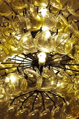 Close up Contemporary chandelier made of many yellow coffee cups
