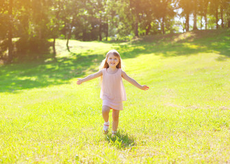 Naklejka na ściany i meble Sunny photo happy little child enjoying summer day and having fu