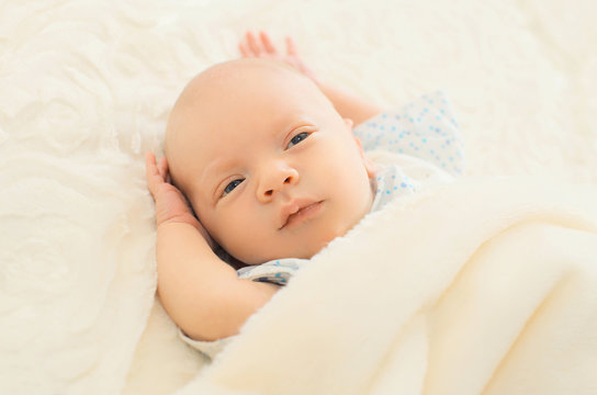 Portrait of sleep infant on the bed at home