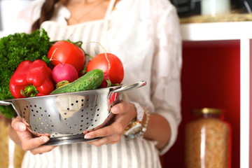 Young woman standing near desk in the kitchen