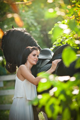 Attractive elegant female with horse, sunny summer day