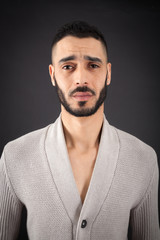 Obraz premium Handsome man doing different expressions in different sets of clothes: sad
