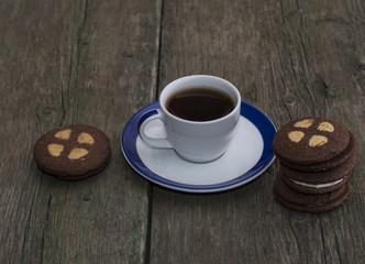 beautiful still life of coffee and cookies on an old table