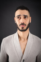 Obraz premium Handsome man doing different expressions in different sets of clothes: thinking