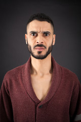 Handsome man doing different expressions in different sets of clothes: angry