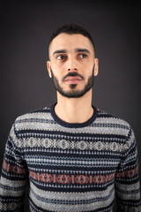 Handsome man doing different expressions in different sets of clothes: thinking