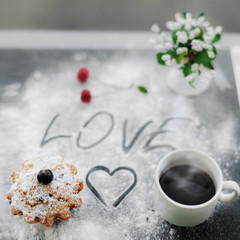 Fototapeta na wymiar Shot of fresh english muffin and coffee for breakfest for lover. Image of romantic breakfast in bed with muffin, coffee, cherry, flowers on background of sugar inscription LOVE