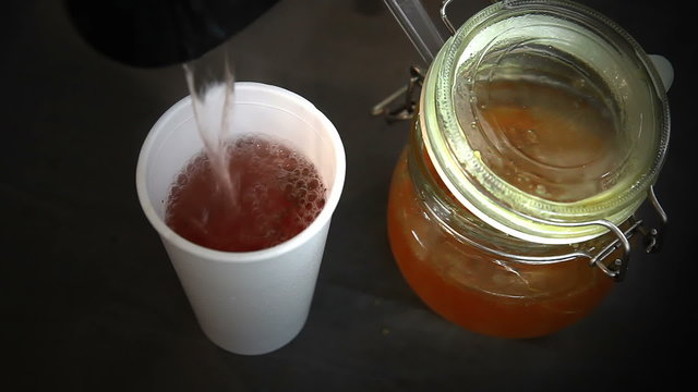 Preparation of herbal tea with jam.