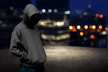 Faceless man in hood on the rooftop - obrazy, fototapety, plakaty