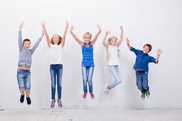 Obraz premium Group of happy young people jumping on white background