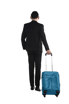 Back view of business man walking with suitcase