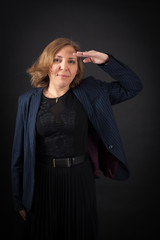 Beautiful woman doing different expressions in different sets of clothes: at attention