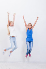 Group of happy young girls jumping  on white background