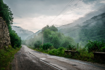 Fototapeta na wymiar Misty road in Caucasus mountains