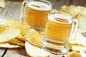 Pair of light beer and chips, unhealthy eating concept, selectiv