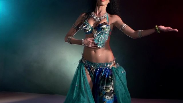 Beautiful young belly dancer continue dancing, slow motion, in