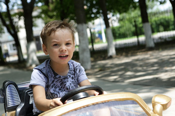 Boy driving a toy car