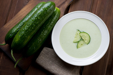 Cucumber cream-soup and fresh cucumbers, selective focus
