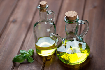 Extra virgin olive oil in glass bottles, wooden background