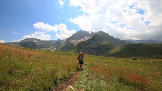 tourist man in mountain with backpack