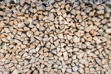 Big pile of birch wood logs stored for winter as background pattern