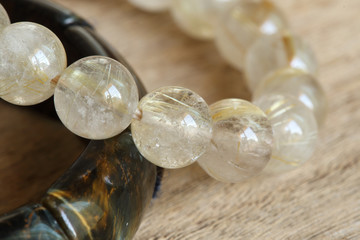 lucky stone bracelets on wood background