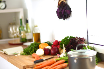 Young woman cutting vegetables in the kitchen