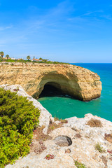 Cave in a cliff on coast of Portugal in Algarve region