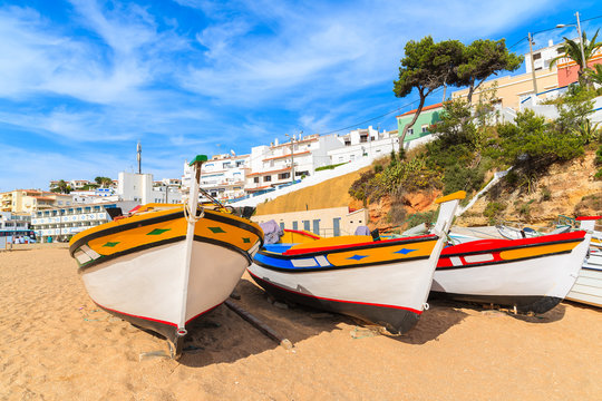 Fototapeta Traditional colourful fishing boats on beach in Carvoeiro village, Algarve region, Portugal