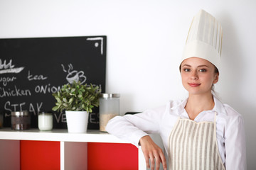 Chef woman portrait with  uniform in the kitchen