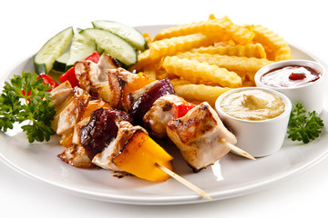 Grilled meat, French fries and vegetables 