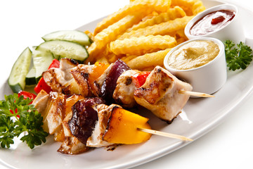 Grilled meat, French fries and vegetables 